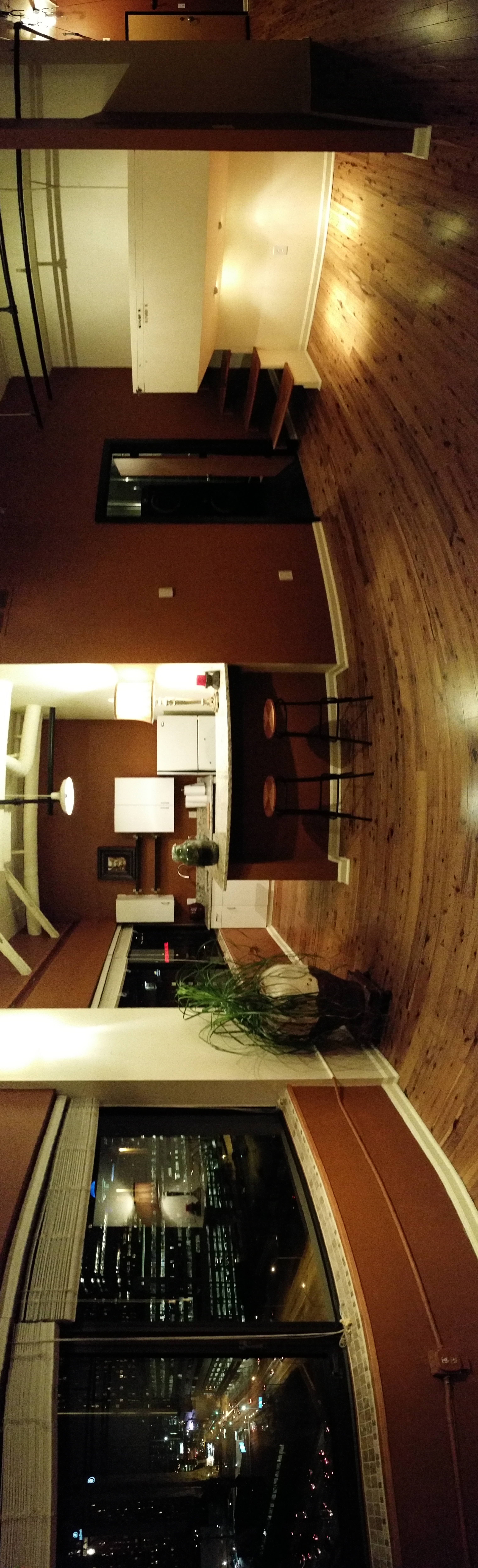 Living area with oversized front windows and city view
